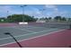 Community tennis court with a net, benches, and lamps at 6709 Rock Bridge Ln, Ellenton, FL 34222