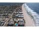 Panoramic aerial view showcasing beachfront condos alongside a scenic coastline and residential neighborhood at 6804 Gulf Dr # 6804, Holmes Beach, FL 34217