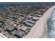 Extensive aerial view displaying coastal community with beachfront condos, waterway access, and residential homes at 6804 Gulf Dr # 6804, Holmes Beach, FL 34217