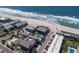 Aerial view of condo buildings and beach with crashing waves on the shore at 6804 Gulf Dr # 6804, Holmes Beach, FL 34217