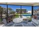 Balcony view showing outdoor seating and the condo complex's pool and landscaped grounds at 6804 Gulf Dr # 6804, Holmes Beach, FL 34217