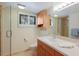 Bright bathroom with wood vanity, shower with glass doors, and modern fixtures at 6804 Gulf Dr # 6804, Holmes Beach, FL 34217
