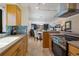 Sunlit kitchen features wood cabinetry, tiled backsplash and view into dining area at 6804 Gulf Dr # 6804, Holmes Beach, FL 34217