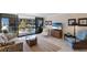 Well-lit living room featuring comfortable seating, stylish decor, and sliding glass doors that open to a balcony at 6804 Gulf Dr # 6804, Holmes Beach, FL 34217