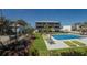 Beautiful condo complex featuring a swimming pool, landscaped grounds, and lounge chairs for residents' enjoyment at 6804 Gulf Dr # 6804, Holmes Beach, FL 34217