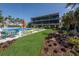 Exterior shot of community pool, building, lawn, and tropical landscaping at 6804 Gulf Dr # 6804, Holmes Beach, FL 34217