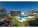 Beautiful condo complex featuring a swimming pool, landscaped grounds, and lounge chairs for residents' enjoyment at 6804 Gulf Dr # 6804, Holmes Beach, FL 34217