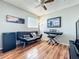 Bedroom featuring a futon sofa, musical keyboard, and laminate wood flooring at 6881 Whitman Way, Sarasota, FL 34243