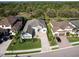Aerial view of a well-landscaped home with a paver driveway in a beautiful neighborhood setting at 7095 Tamworth Pkwy, Sarasota, FL 34241