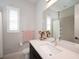 Bright bathroom featuring a single sink vanity, framed mirror, tile floors and shower with tile surround at 7095 Tamworth Pkwy, Sarasota, FL 34241