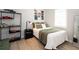 Well-lit bedroom with light-colored wood floors, shelving and decor at 7095 Tamworth Pkwy, Sarasota, FL 34241