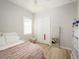 Bright bedroom features light-colored floors, a window and a full-length mirror at 7095 Tamworth Pkwy, Sarasota, FL 34241