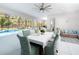 Dining room with screened in patio, pool views, and modern decor at 7095 Tamworth Pkwy, Sarasota, FL 34241