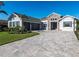 Charming home with stone accents, three-car garage, and paver driveway at 7095 Tamworth Pkwy, Sarasota, FL 34241
