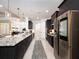 Spacious kitchen boasts granite countertops, dark cabinets, and stainless steel appliances at 7095 Tamworth Pkwy, Sarasota, FL 34241