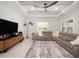 Relaxing living room with a large sectional sofa and modern ceiling fan at 7095 Tamworth Pkwy, Sarasota, FL 34241