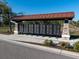 Community mailboxes with stone supports and metal roof at 7095 Tamworth Pkwy, Sarasota, FL 34241