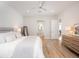 Spacious main bedroom with light-colored floors, neutral paint and ensuite bathroom at 7095 Tamworth Pkwy, Sarasota, FL 34241