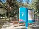 Park signage displays rules with seating for dog park visitors at 7095 Tamworth Pkwy, Sarasota, FL 34241