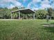 Covered picnic area with tables on a lush green lawn, great for outdoor gatherings at 7095 Tamworth Pkwy, Sarasota, FL 34241