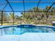 Stunning backyard pool featuring a serene water feature and a spacious screened enclosure at 7095 Tamworth Pkwy, Sarasota, FL 34241