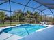 Beautiful screened-in pool with pristine blue water and comfortable lounge chairs, perfect for relaxation at 7095 Tamworth Pkwy, Sarasota, FL 34241