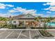 Community clubhouse featuring a pool, lounge area, and well-manicured landscaping under a bright blue sky at 732 157Th E Ct, Bradenton, FL 34212