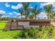 Community entrance sign featuring stone accents and lush landscaping under a bright blue sky at 732 157Th E Ct, Bradenton, FL 34212