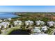 Picturesque aerial view of community showing condo buildings, lake, pool, and waterfront access at 7730 34Th W Ave # 103, Bradenton, FL 34209