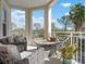 Relax on the balcony with comfortable seating and enjoy the lush landscape and blue skies at 7730 34Th W Ave # 103, Bradenton, FL 34209