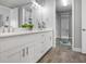 Bright bathroom boasts a double vanity, white cabinetry, quartz counters, and walk in closet at 7730 34Th W Ave # 103, Bradenton, FL 34209