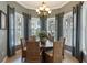 Bright dining room with a chandelier, a round table with six chairs, and large windows with views of the outdoors at 7730 34Th W Ave # 103, Bradenton, FL 34209