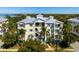 Beautiful building aerial with large balconies, lush landscaping, and community walk-up at 7730 34Th W Ave # 103, Bradenton, FL 34209