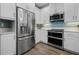 The kitchen features stainless steel appliances and white cabinetry at 7730 34Th W Ave # 103, Bradenton, FL 34209