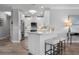 Modern kitchen with white cabinetry, stainless steel appliances, a marble countertop island, and stylish bar stools at 7730 34Th W Ave # 103, Bradenton, FL 34209