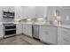 This contemporary kitchen is equipped with stainless steel appliances and a tile backsplash at 7730 34Th W Ave # 103, Bradenton, FL 34209