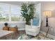 Cozy living area with a comfortable chair, decorative side table, and stylish window shutters for natural light at 7730 34Th W Ave # 103, Bradenton, FL 34209