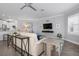 Bright living room with comfortable seating, modern ceiling fan and beautiful view from window with plantation shutters at 7730 34Th W Ave # 103, Bradenton, FL 34209