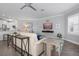 Bright living room with comfortable seating, modern ceiling fan and beautiful view from window with plantation shutters at 7730 34Th W Ave # 103, Bradenton, FL 34209