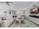 Bright and airy living room with modern furnishings, including a white sectional sofa and a flat-screen TV at 7730 34Th W Ave # 103, Bradenton, FL 34209