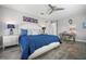 The stylish main bedroom has a ceiling fan, hard floors, and tasteful decor at 7730 34Th W Ave # 103, Bradenton, FL 34209