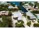 Aerial view of a waterfront home boasting a metal roof, and private canal access at 807 S Bay Blvd, Anna Maria, FL 34216