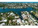 Gorgeous aerial view of a waterfront property with private boat dock on a canal and lush landscaping at 807 S Bay Blvd, Anna Maria, FL 34216
