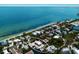 Breathtaking aerial view of the charming waterfront property with lush greenery and stunning ocean backdrop at 807 S Bay Blvd, Anna Maria, FL 34216