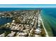 Picturesque aerial shot of homes along winding canals, near pristine beaches, and the beautiful open ocean at 807 S Bay Blvd, Anna Maria, FL 34216