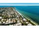 Expansive aerial view of a coastal community with beach access and waterfront homes along winding canals at 807 S Bay Blvd, Anna Maria, FL 34216