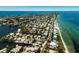 Overhead view of a vibrant coastal community, showcasing canals, homes, beaches and the open ocean beyond at 807 S Bay Blvd, Anna Maria, FL 34216