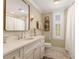 Well-lit bathroom featuring a large mirror, single sink, and marble floors at 807 S Bay Blvd, Anna Maria, FL 34216