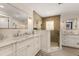 Elegant bathroom featuring marble countertops, dual sinks, tiled shower, and modern fixtures at 807 S Bay Blvd, Anna Maria, FL 34216