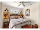 Comfortable bedroom with a ceiling fan, a decorative shell mirror, and coastal décor at 807 S Bay Blvd, Anna Maria, FL 34216